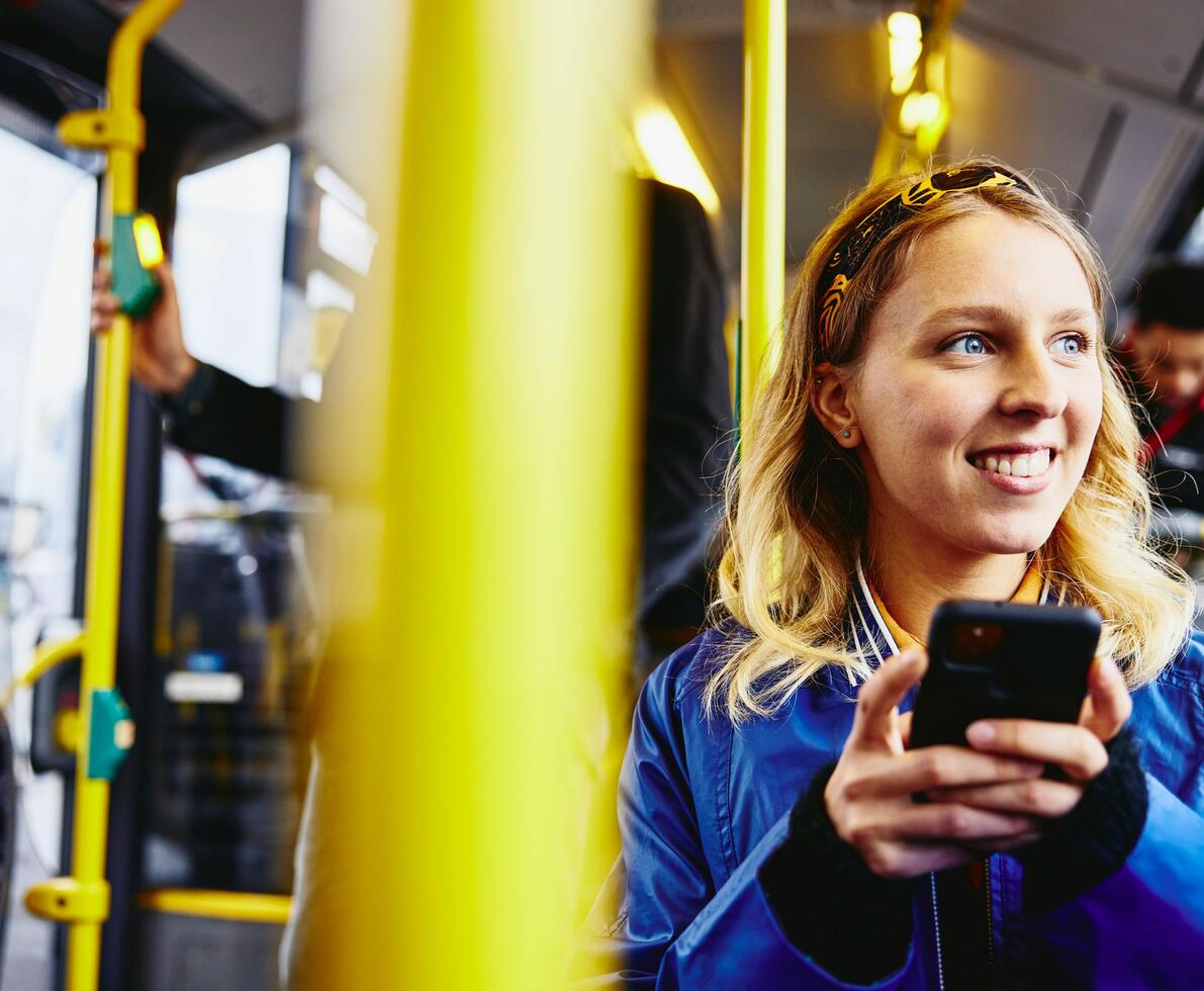 ragazza sull'autobus che guarda il telefono